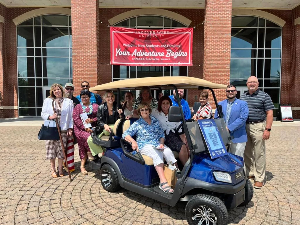 group of people on and around a golf cart